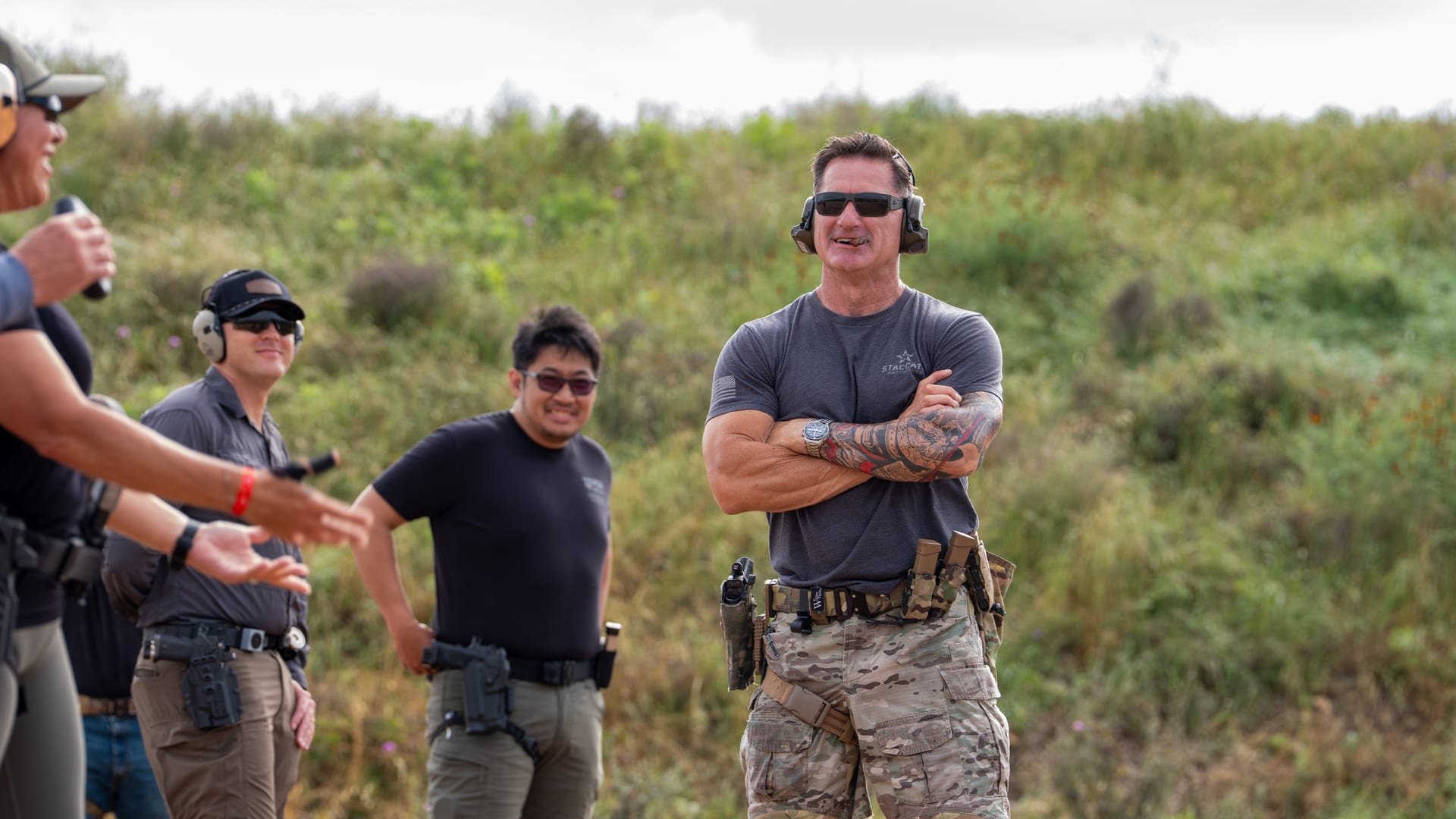 An instructor briefing shooters on the line