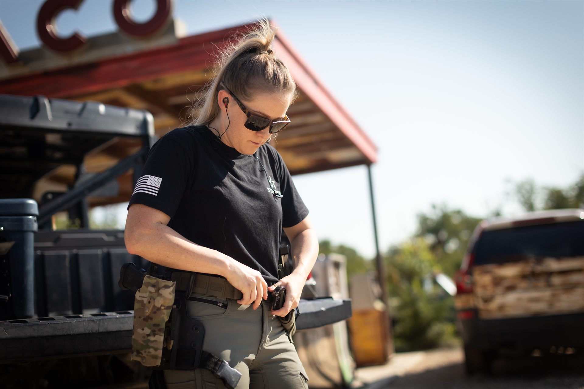 A shooter gearing up beside a truck before a course run