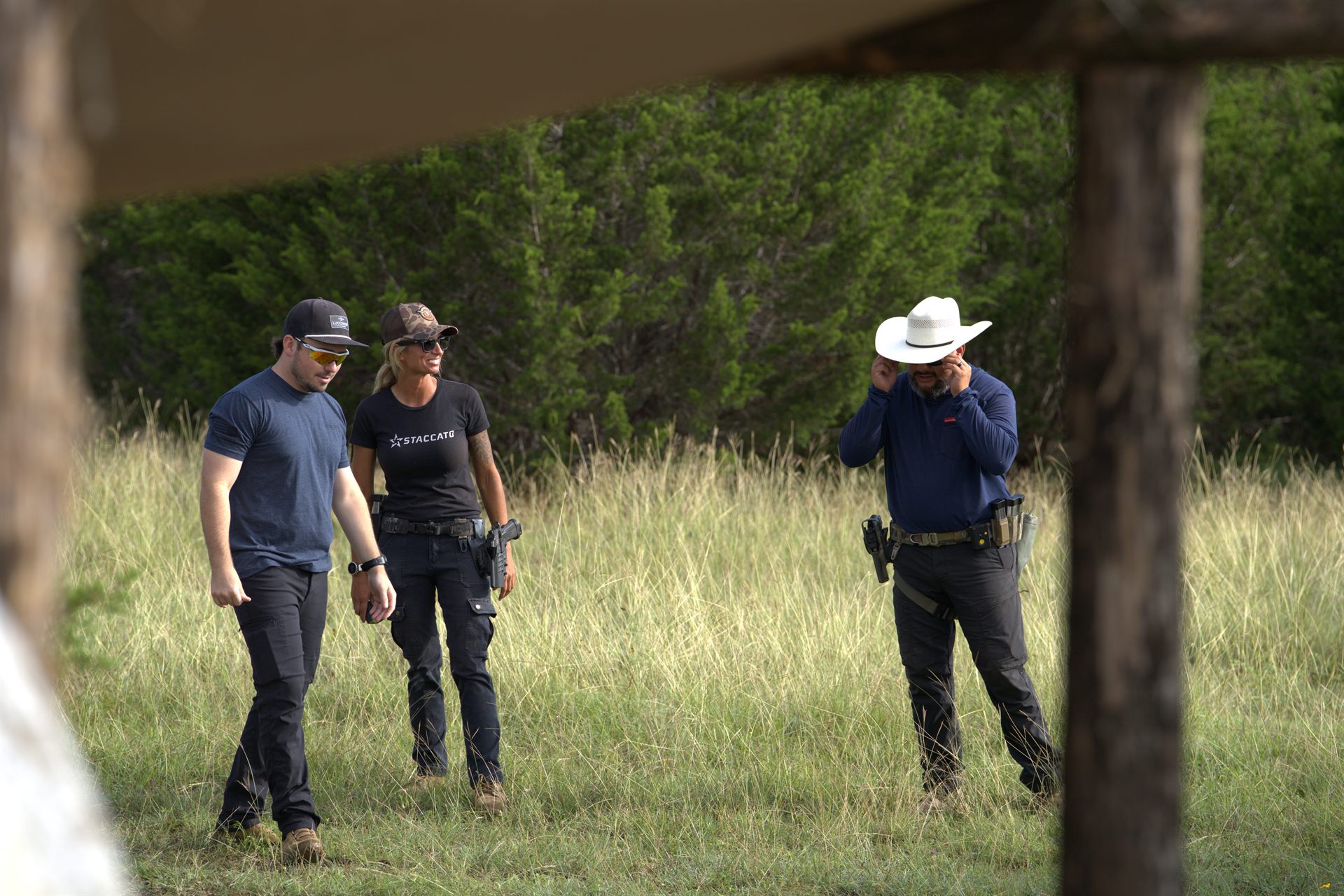 Three shooters walking out across the Texas field together