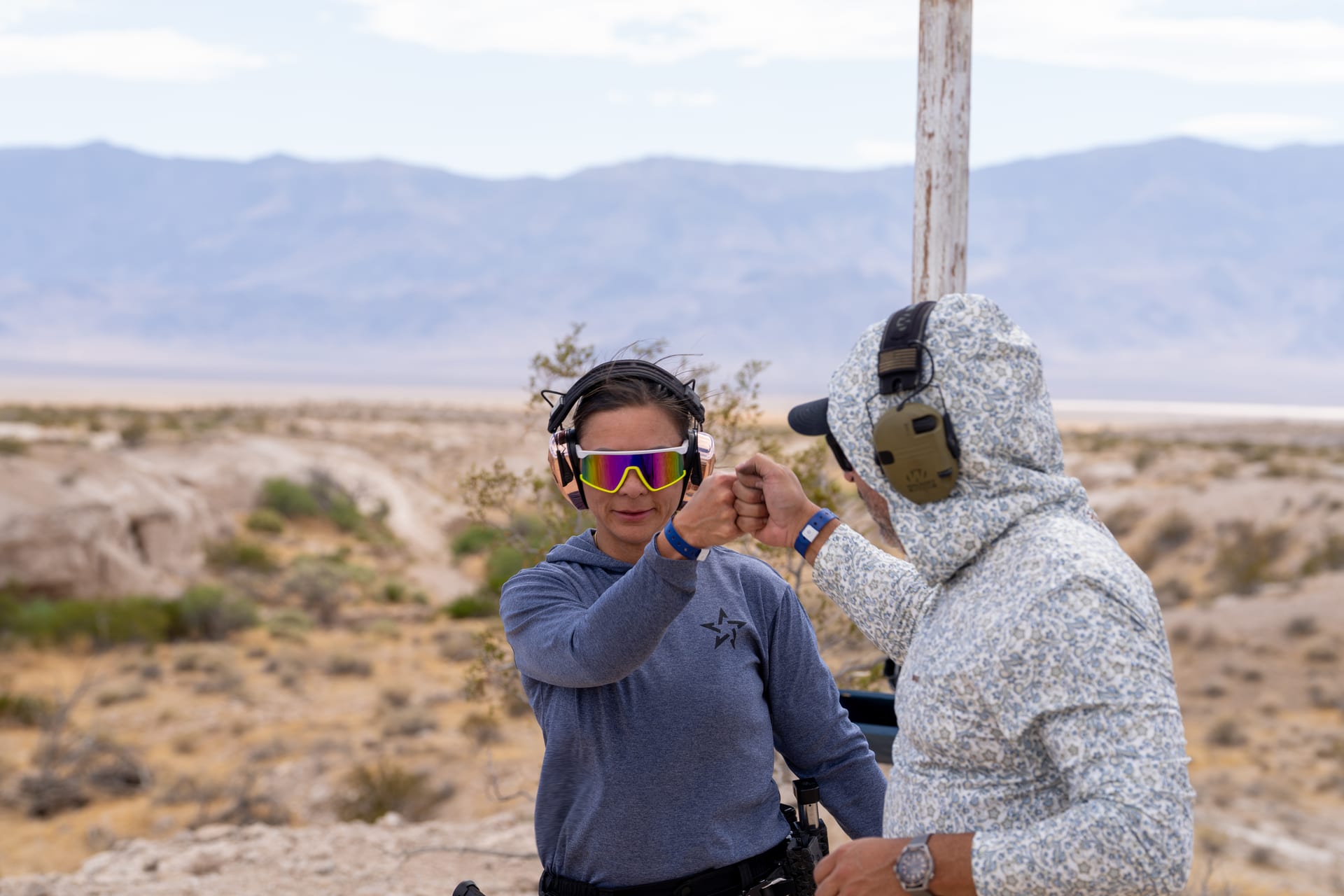 Two shooters bumping fists on a Nevada bay